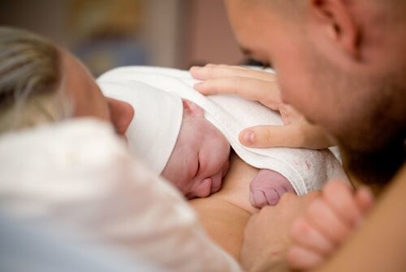 Couple holding newborn baby